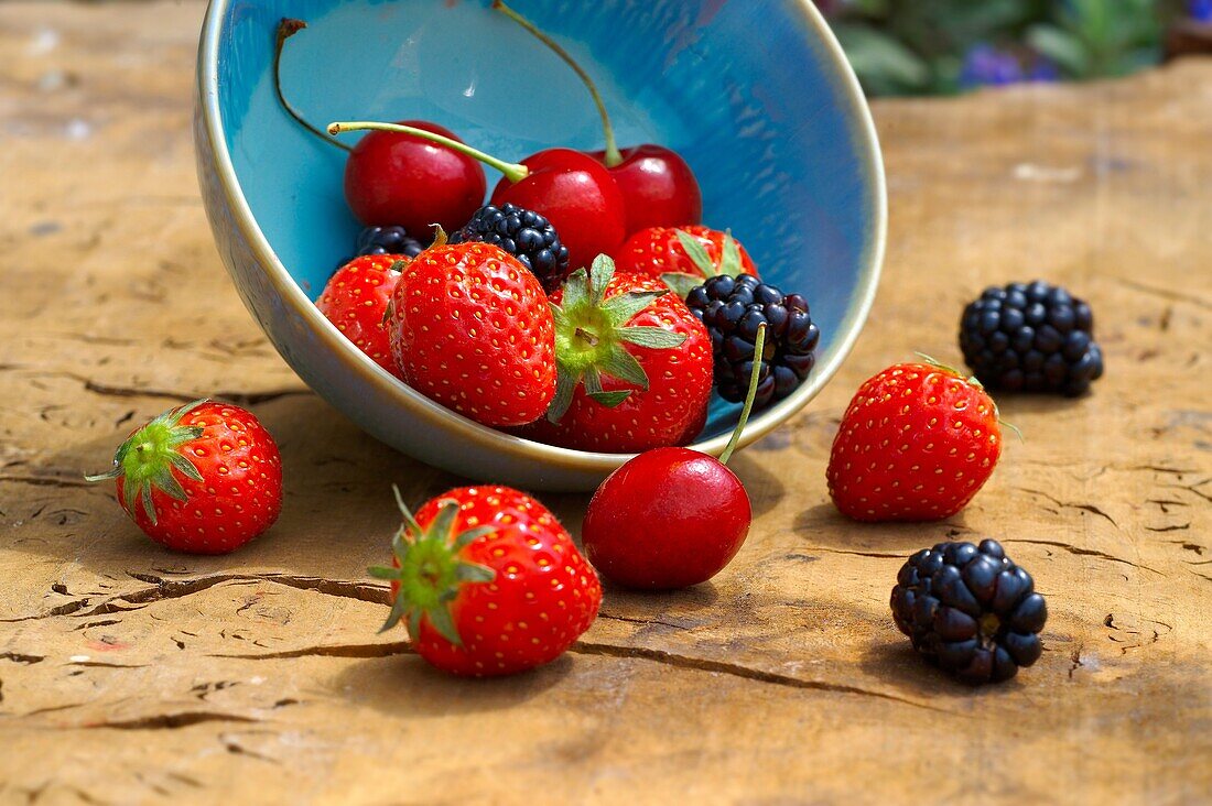 Mixed summer fruits - strawberries, cherries, blackberries