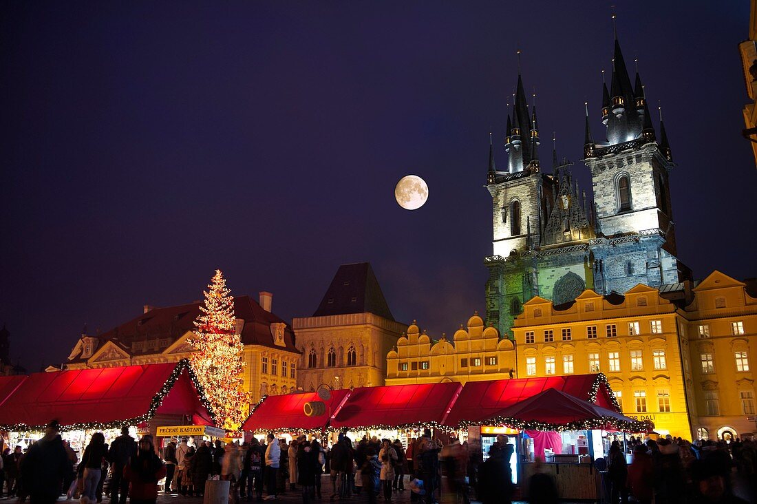 Christmas Market In Prague's Old Town Square with Church Of Out Lady Before Tyn at night