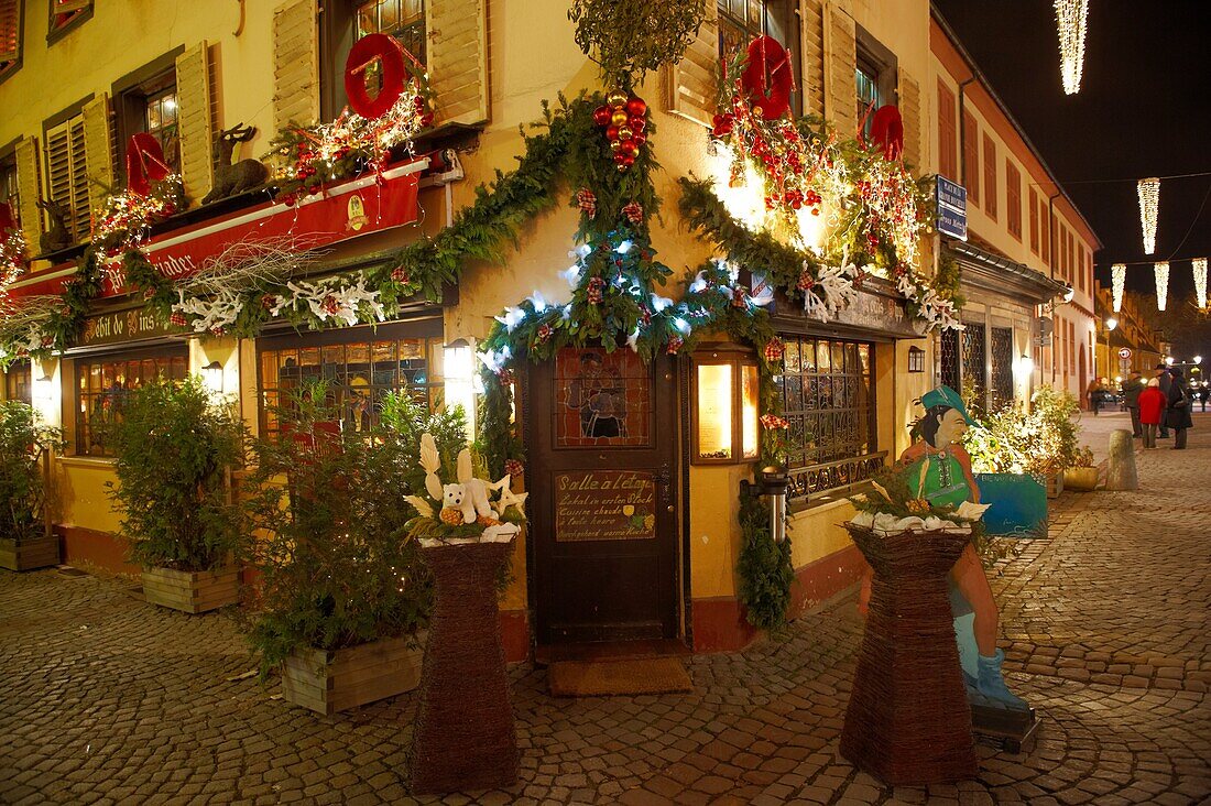 Traditional festive restaurant at night with christmas lights and decorations - Strasbourg, Alsace France