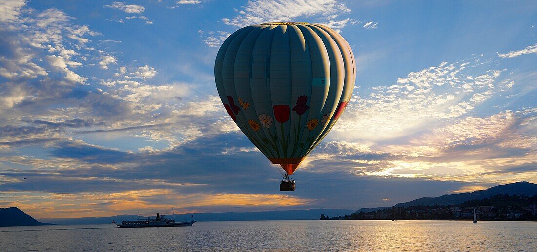 Sunset over Lac Leman lake Geneva with a hot air balloon - Montraux Switzerland