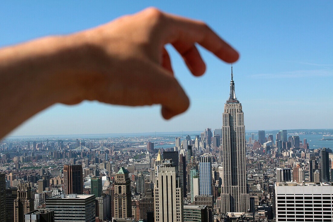 Finger Touching the Top of the Empire State Building, Seen From the Top of the Rock, Observation Deck in Rockefeller Center, Midtown Manhattan, New York City, New York State, United States
