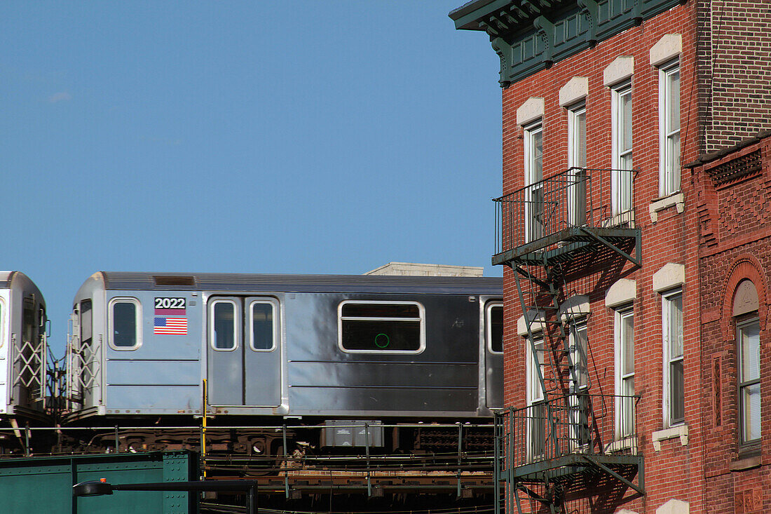 Elevated Train Rocking An Old Building in the Borough of Queens, New York City, New York State, United States