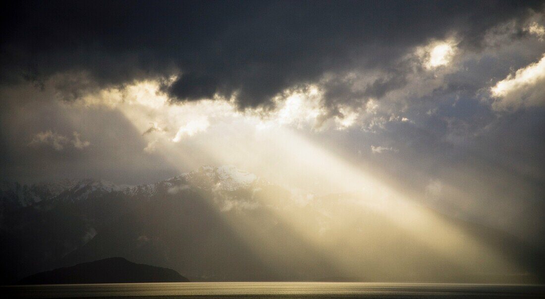 New Zealand, Southland, Fiordland National Park Dramatic light as a storm clears from the moutain peaks surrounding Lake Te Anau