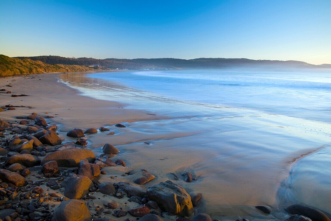 New Zealand, Southland, The Catlins Looking across the golden sands of Porpoise Bay shortly after sunrise