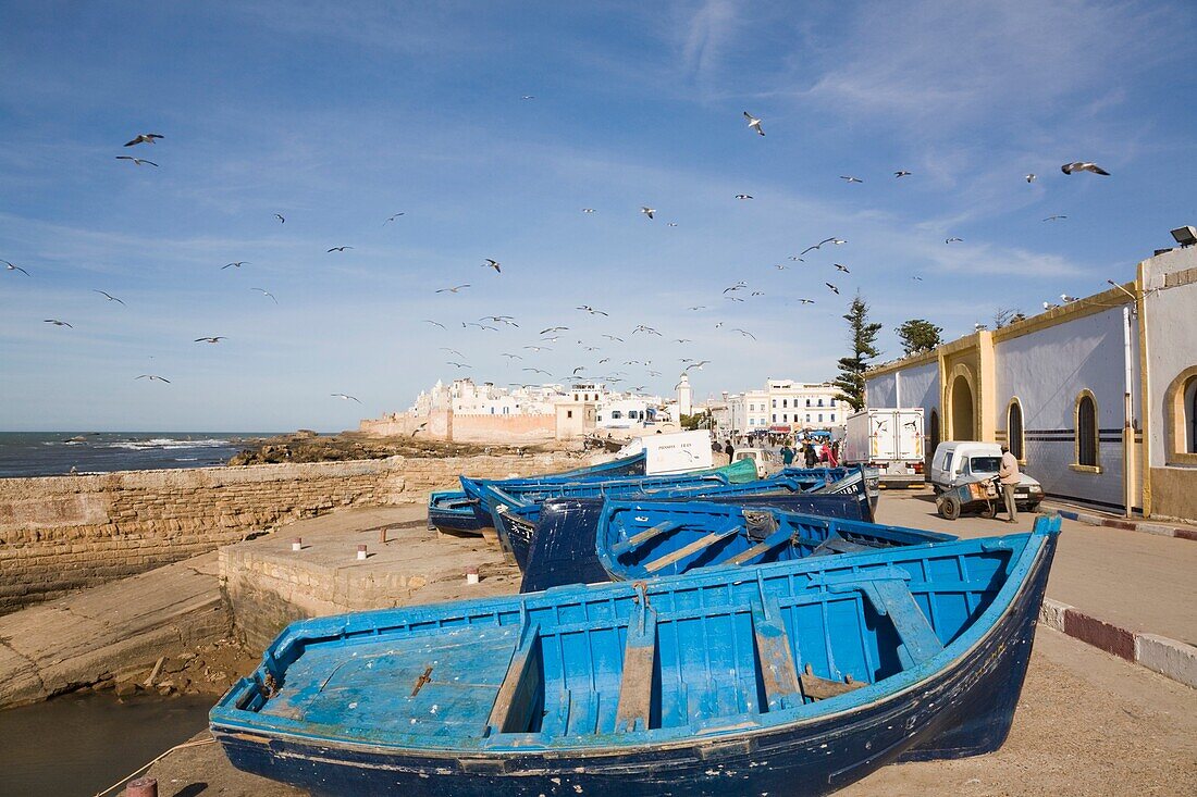 Essaouira Morocco Small wooden fishing boats on seafront by Port Authority building Formerly Mogador