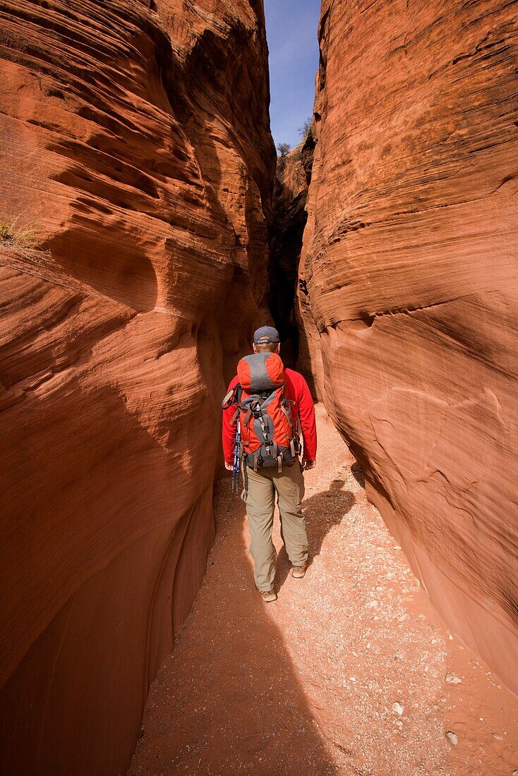 Hiker in the Navajo Sandstone narrows of Buckskin Gulch in the Paria Canyons - Vermilion Cliffs Wilderness Area, Utah