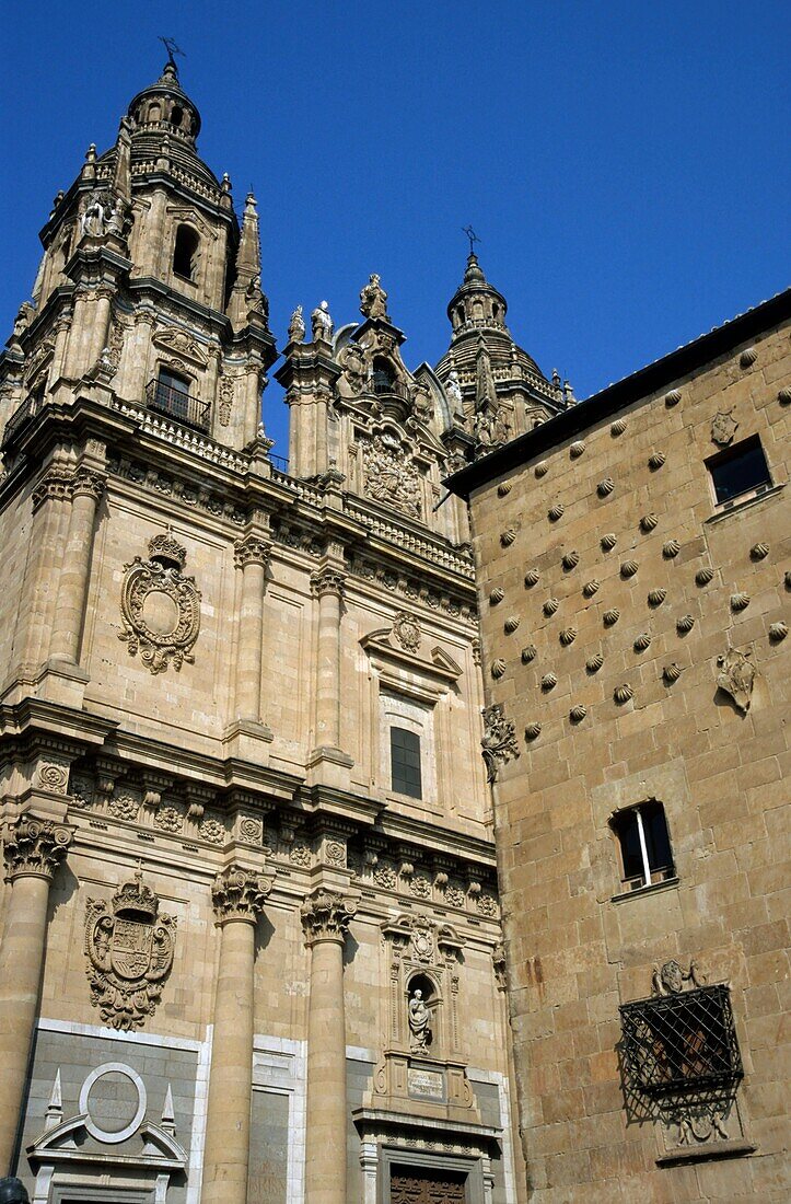 Facade of Real Clericia de San Marcos on left and Public Library on right with scallop, Spain Salamanca