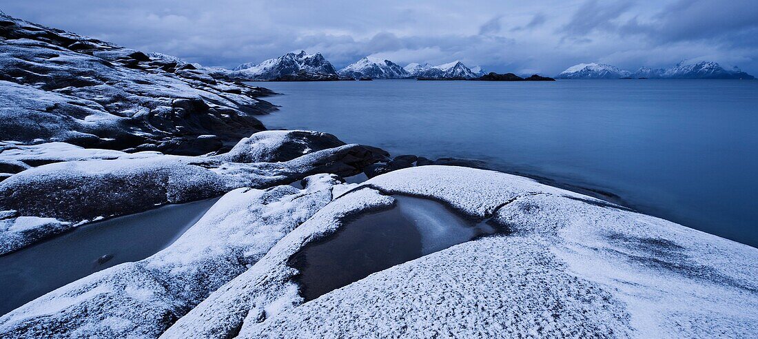Snow covered rocky coastline at Stamsund, Vestvågøy, Lofoten islands, Norway