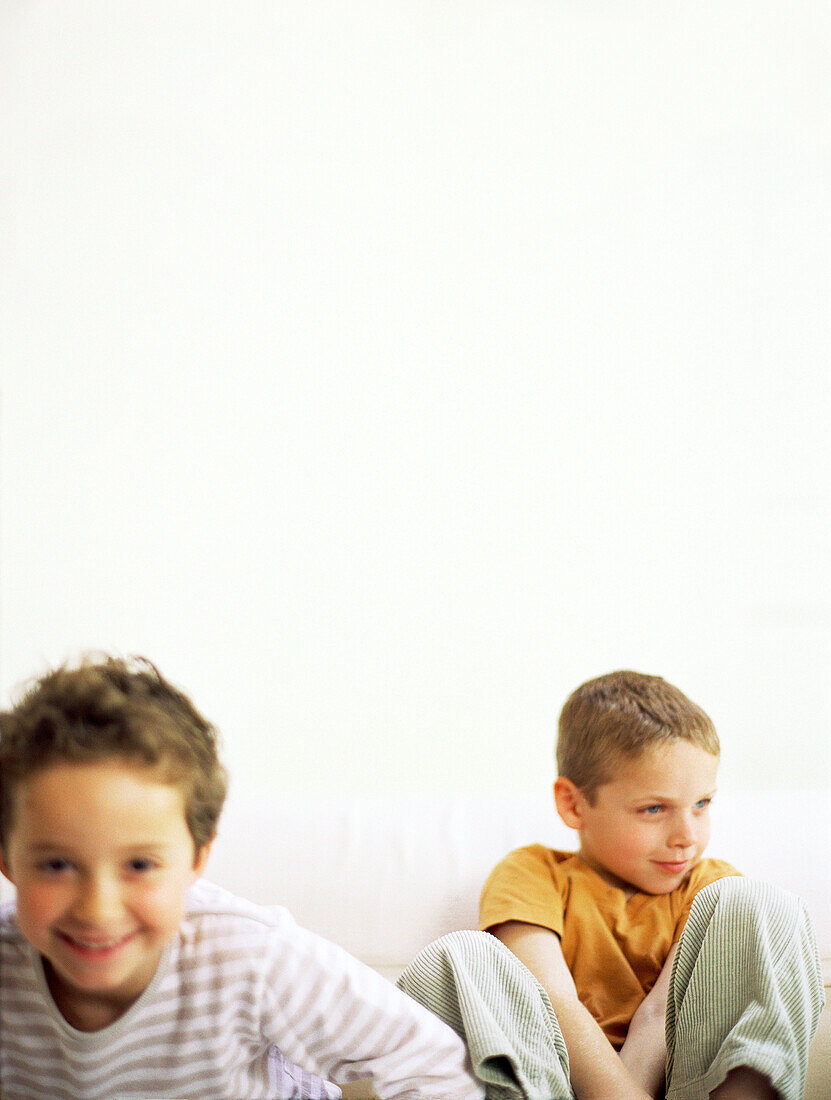 Two boys sitting on sofa