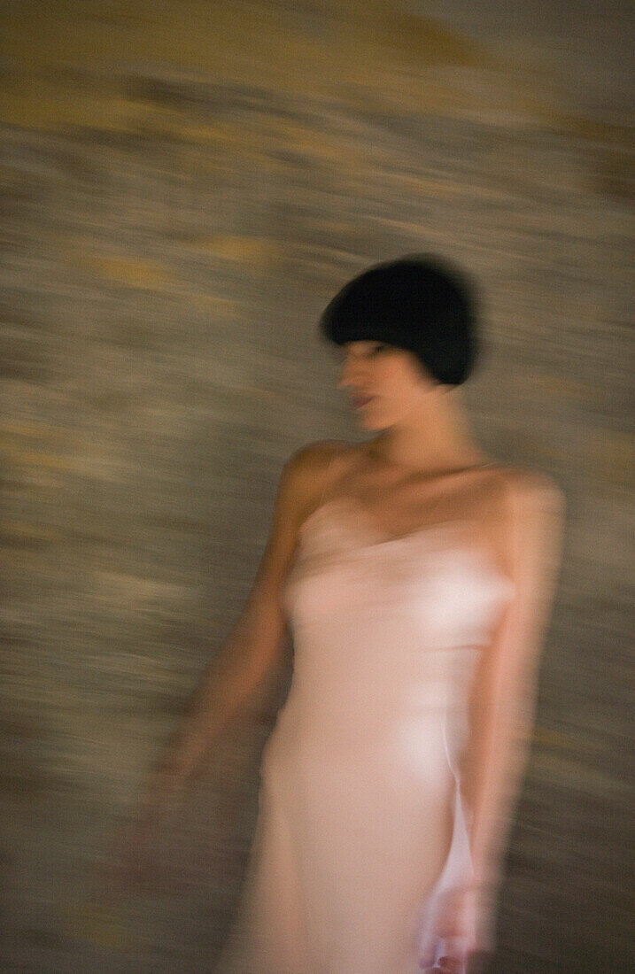 Woman wearing slip, three quarter length, blurred