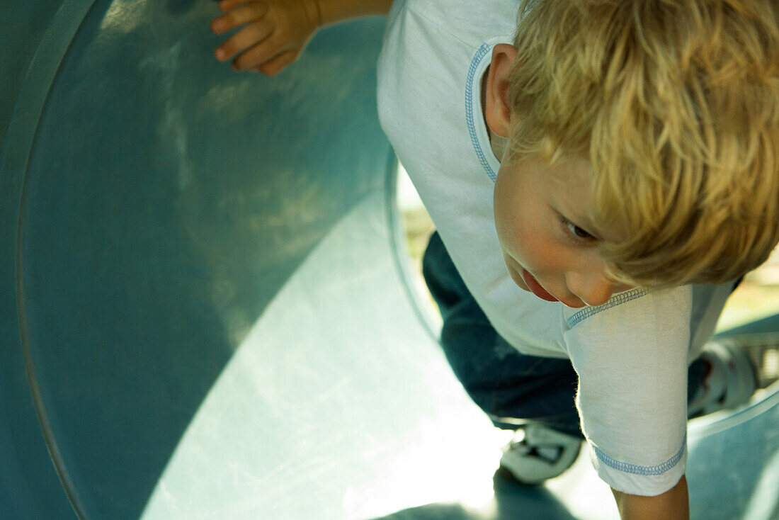 Boy on playground equipment, cropped, close-up