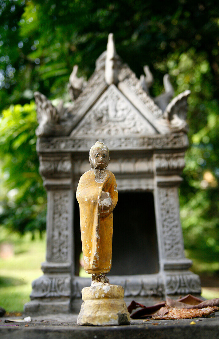 Religious Statue In Front of Stone Temple, Phnom Penh, Cambodia
