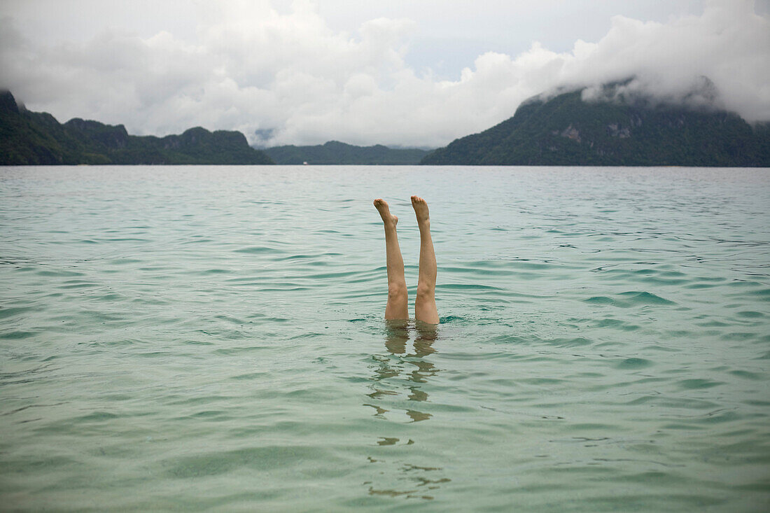 Woman’s Legs Sticking Out of Water