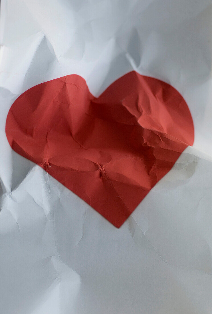 Crumpled Red Heart on Paper