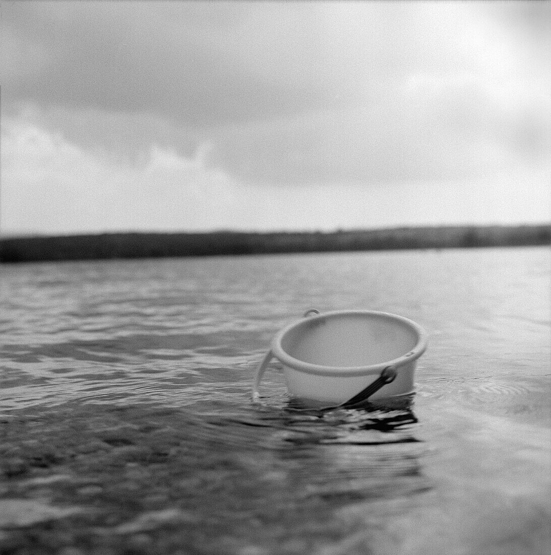 Bucket Floating in Lake