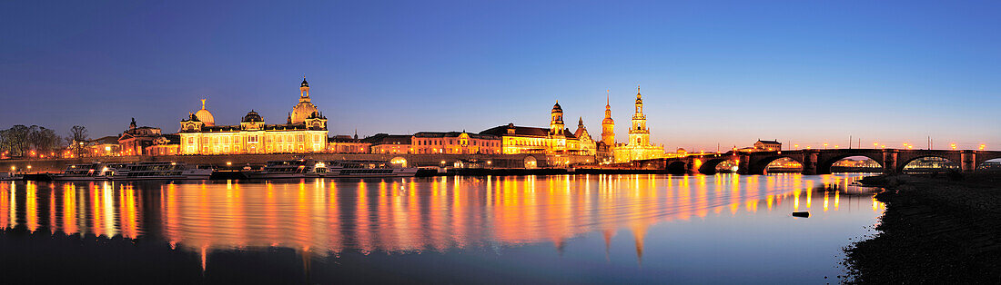 View over river Elbe to illuminated old town, Dresden, Saxony, Germany