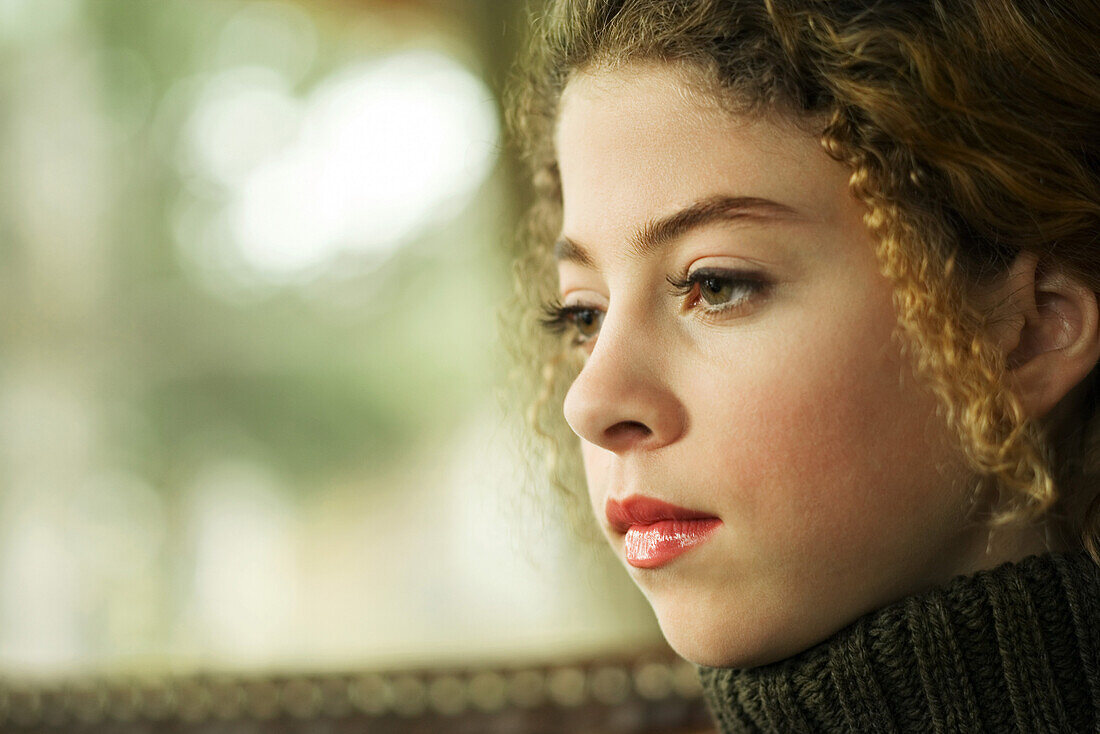 Teenage girl looking away, close-up