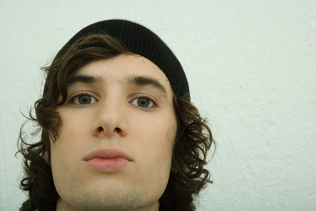 Young man staring at camera, close-up