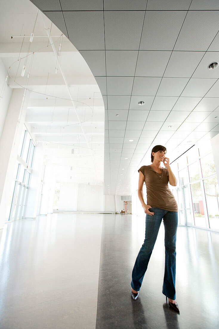 Woman in lobby, talking on cell phone