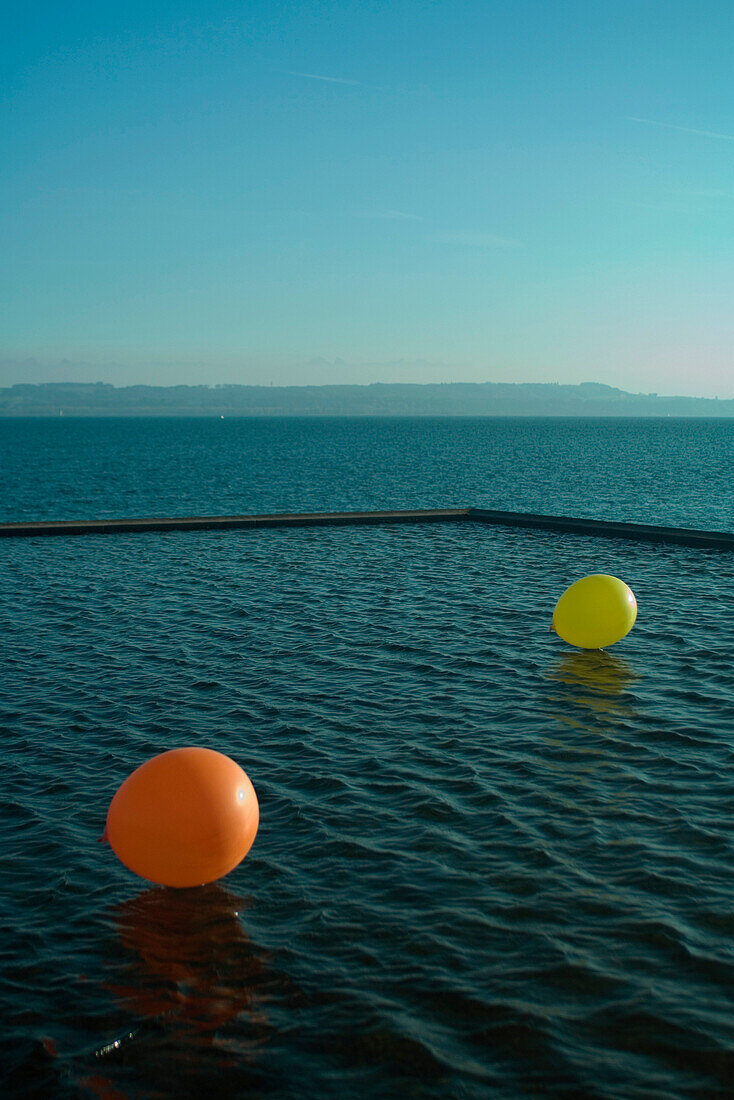 Two balloons on water
