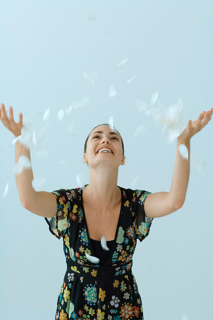 Woman tossing flower petals into air