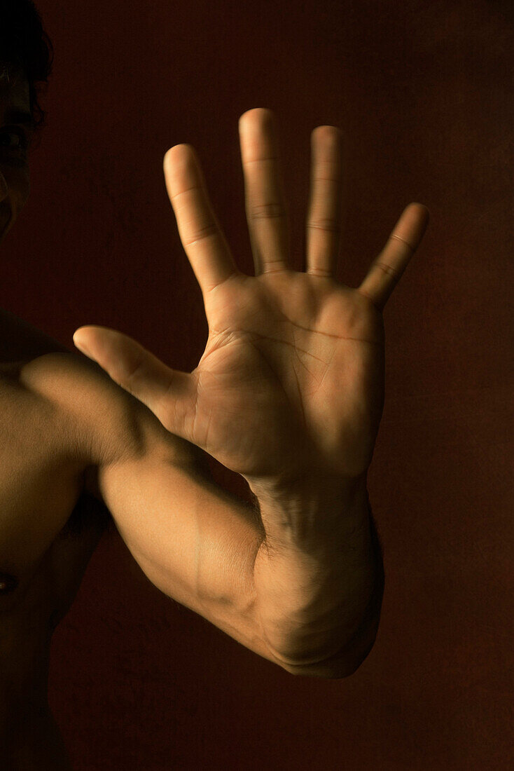 Man's hand raised making stop gesture