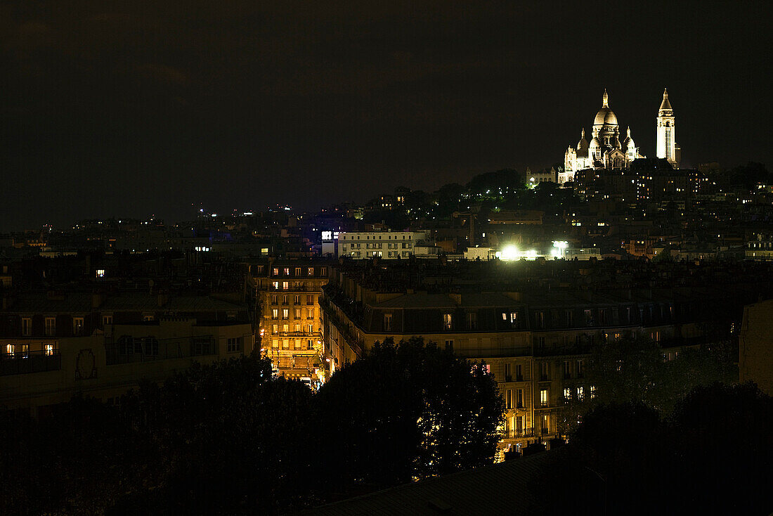 France, Paris at night, Sacre Coeur illuminated in background