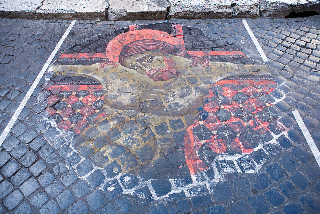 Italy, Rome, mural of Jesus Christ painted on cobblestone street