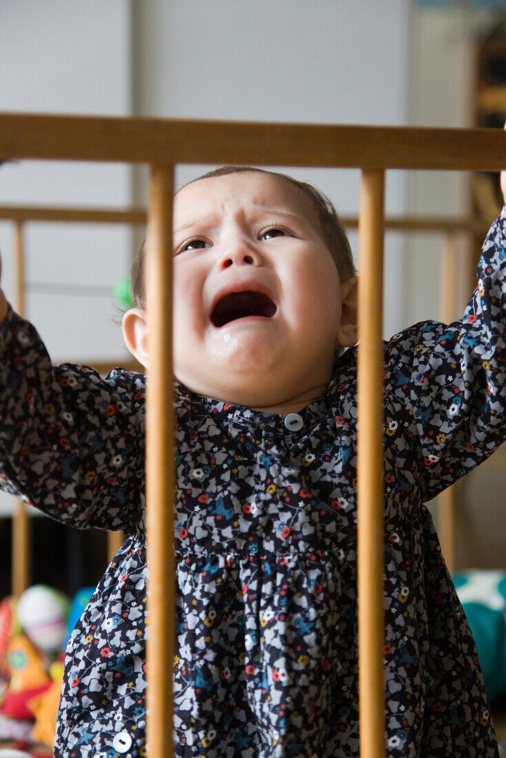 Baby girl crying in crib