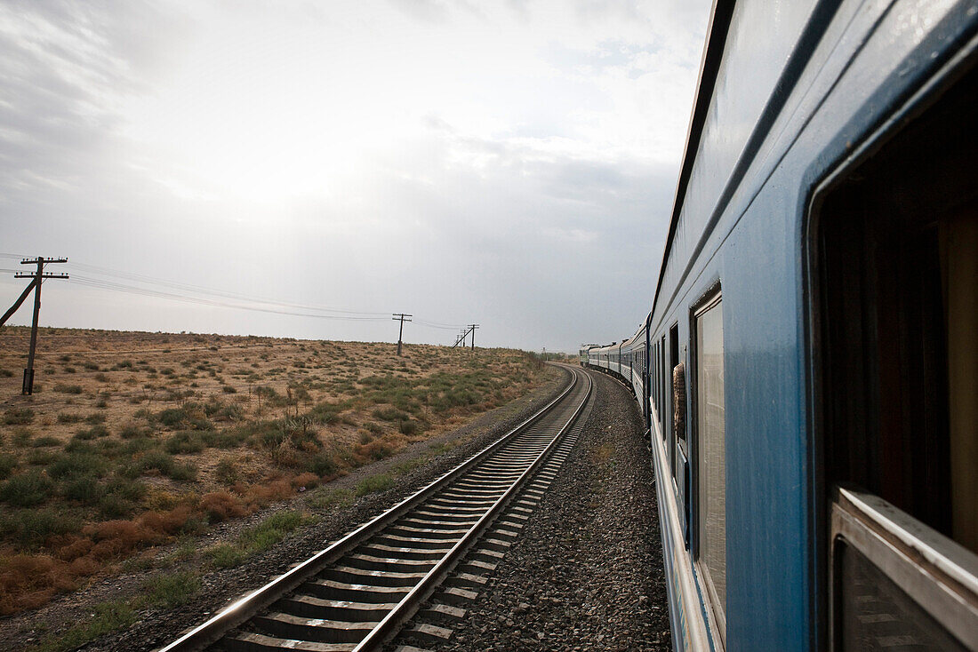 Uzbekistan, passenger train traveling through the ancient Silk Road