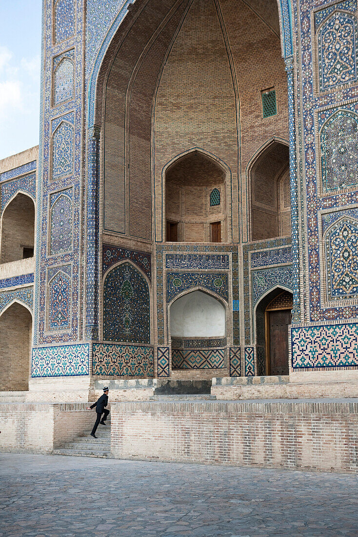 Uzbekistan, Bukhara, Mir-i Arab Madrasah, person hurring up the steps