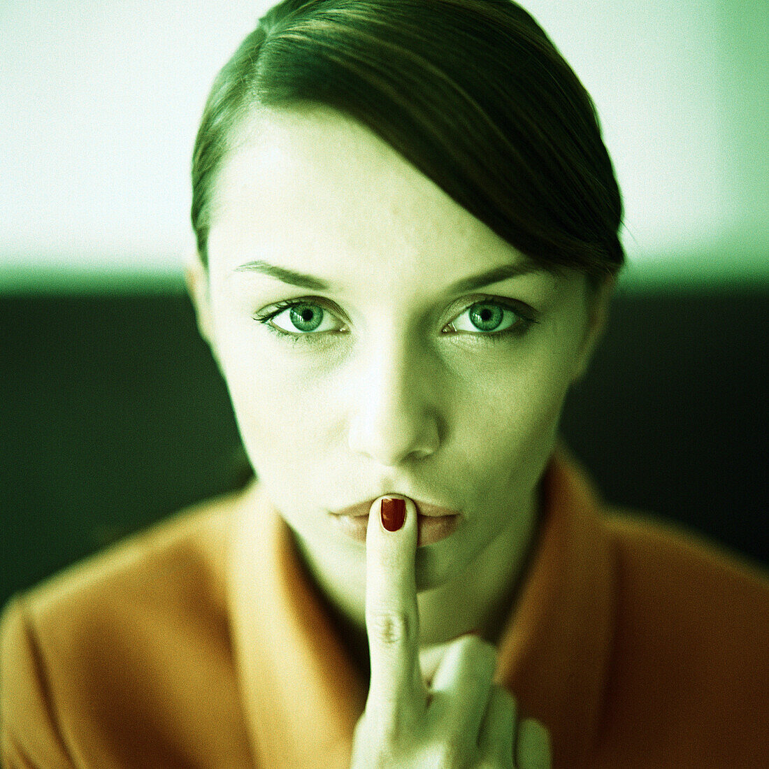 Woman with finger in front of lips