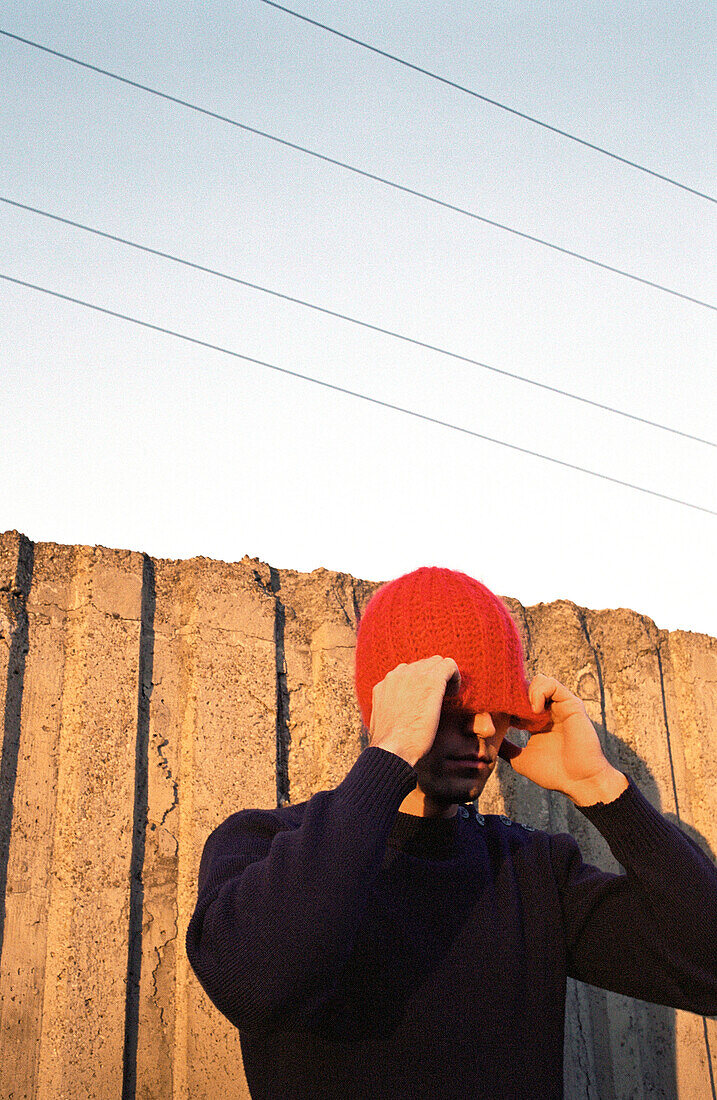 Man adjusting hat