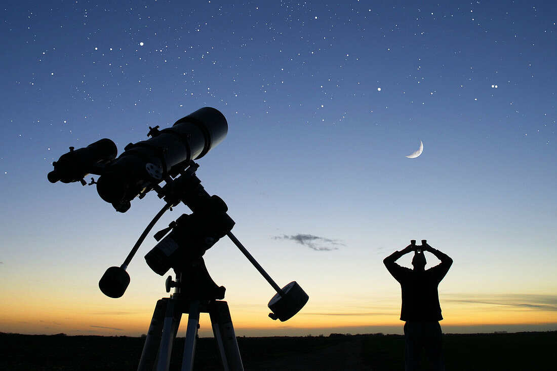 Man looking at sky with binoculars