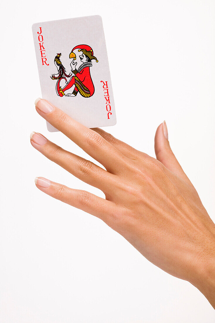 Woman's hand holding a playing card (joker)