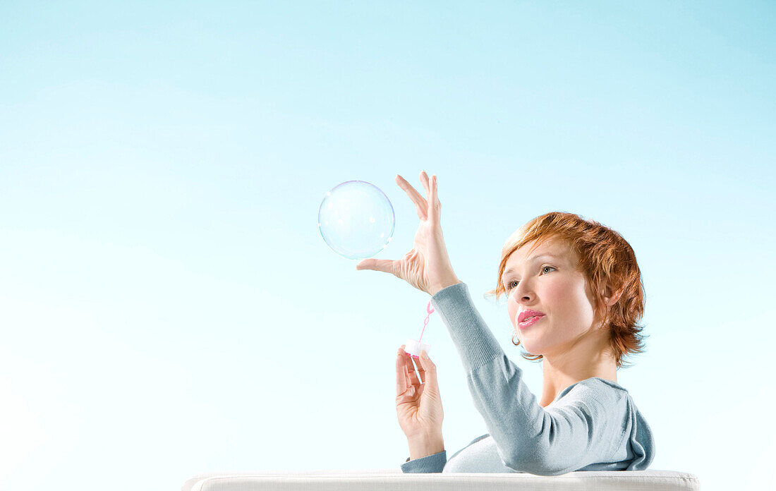 Young woman blowing bubble