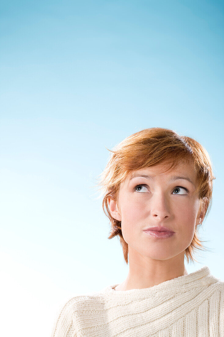 Portrait of young woman looking up