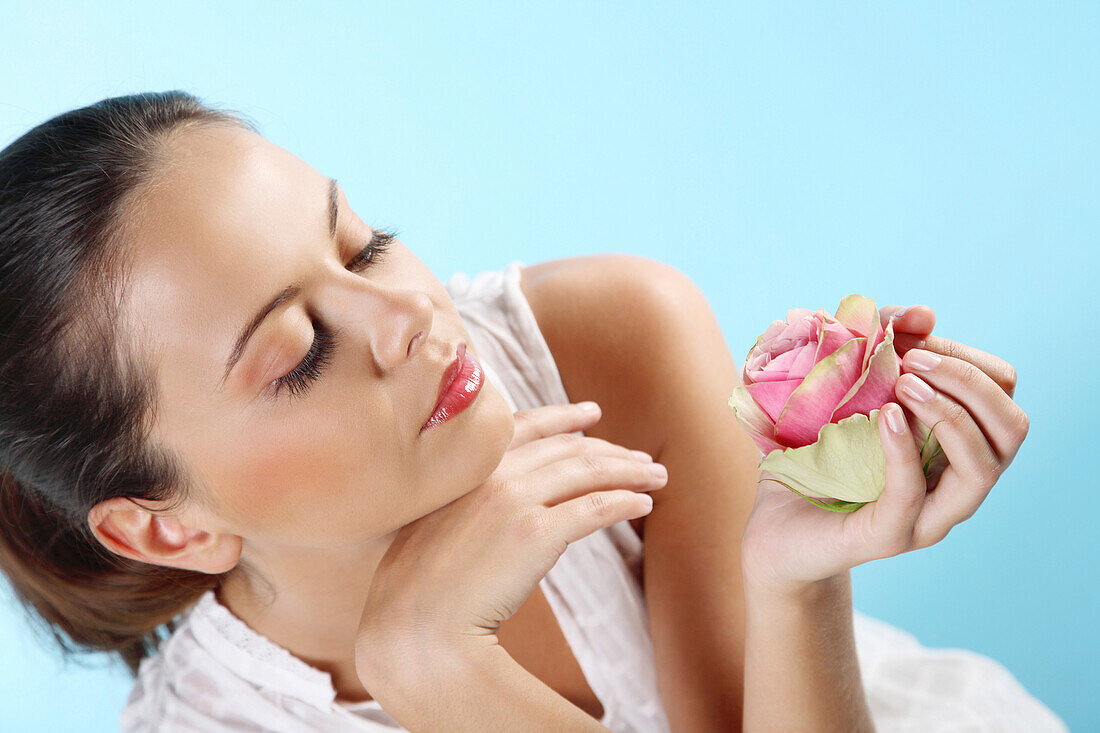 Young woman holding a rose