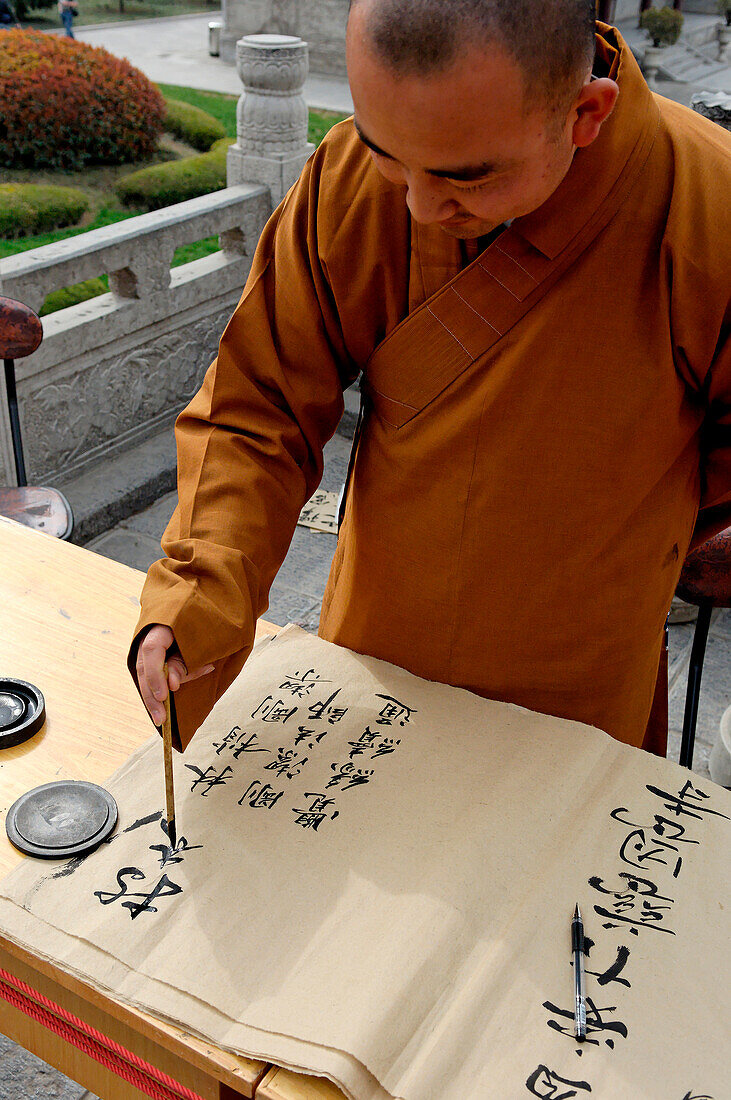 China, Shaanxi, Xian, Giant Wild Goose Pagoda, monk writing in a decorative hand