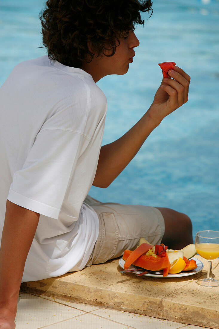 Teen boy eating fruits