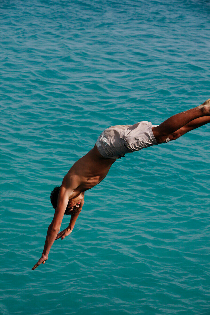 Teen boy diving in the sea