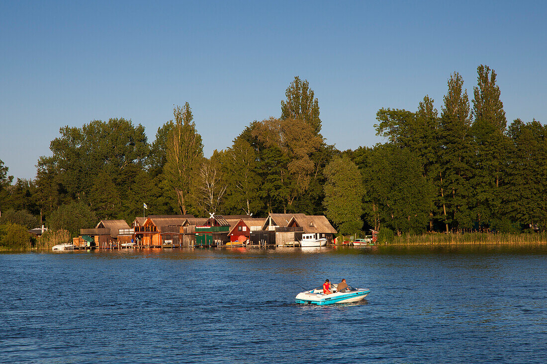 Boathouses and motorboat, at Schwerin lake, Schwerin, Mecklenburg Western-Pomerania, Germany
