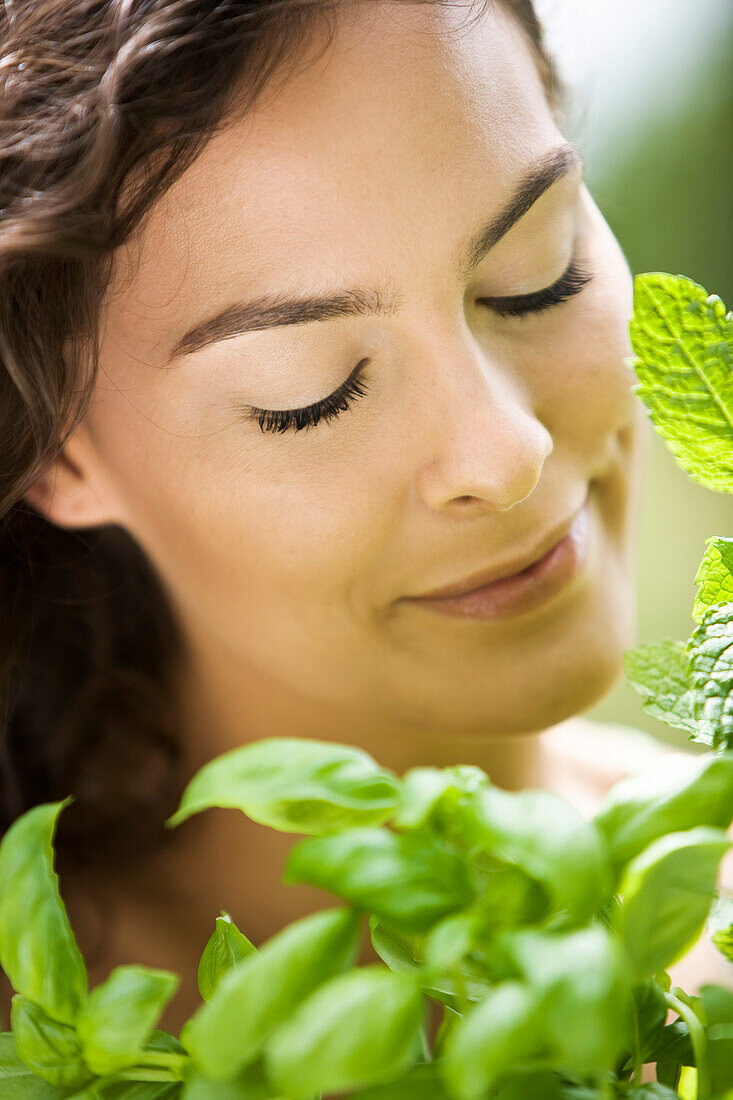 Young woman with aromatic herbs