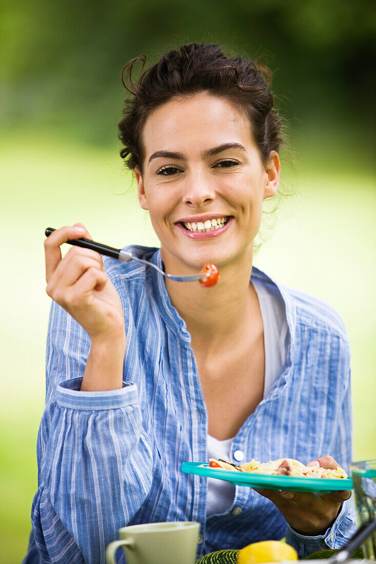 Young woman eating salad