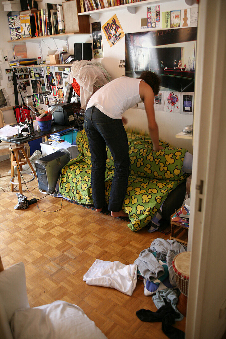 Teenage boy cleaning his bedroom