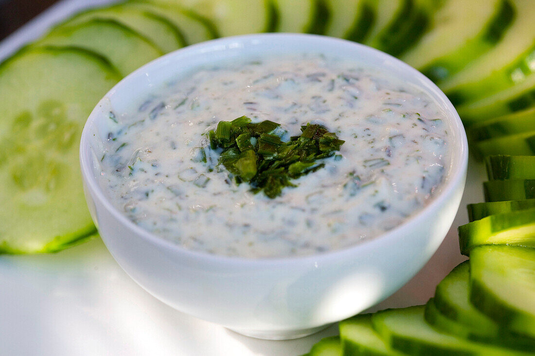 Sauce with fresh cheese and chives in a white bowl