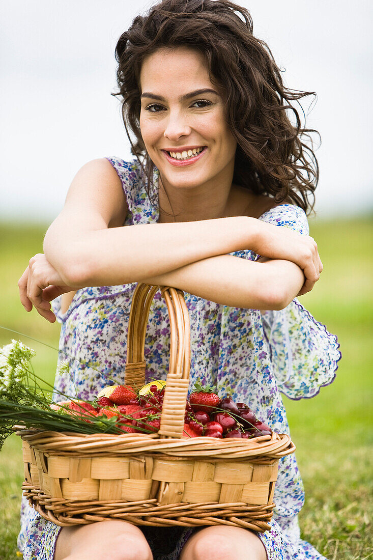 Young woman with a basket full of fruits