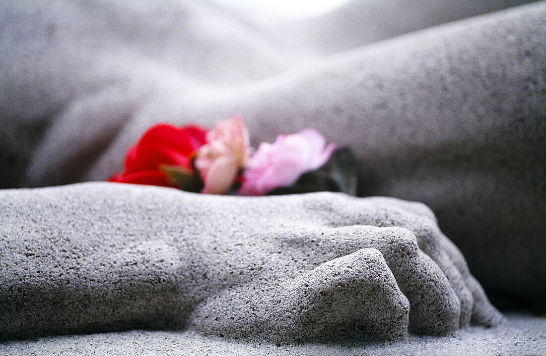 Hand of statue and flowers