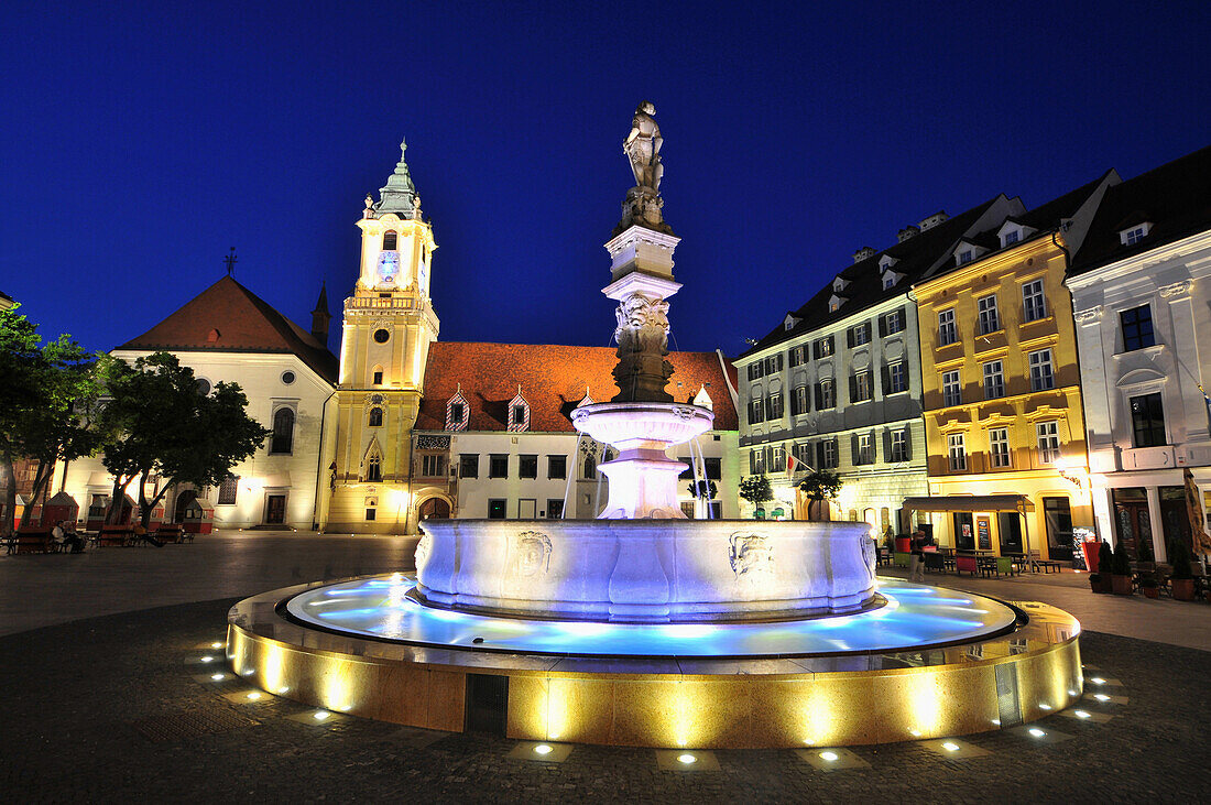 Marketplace with illuminated fountain and old town hall in the evening, old town of Bratislava, Slovakia, Europe