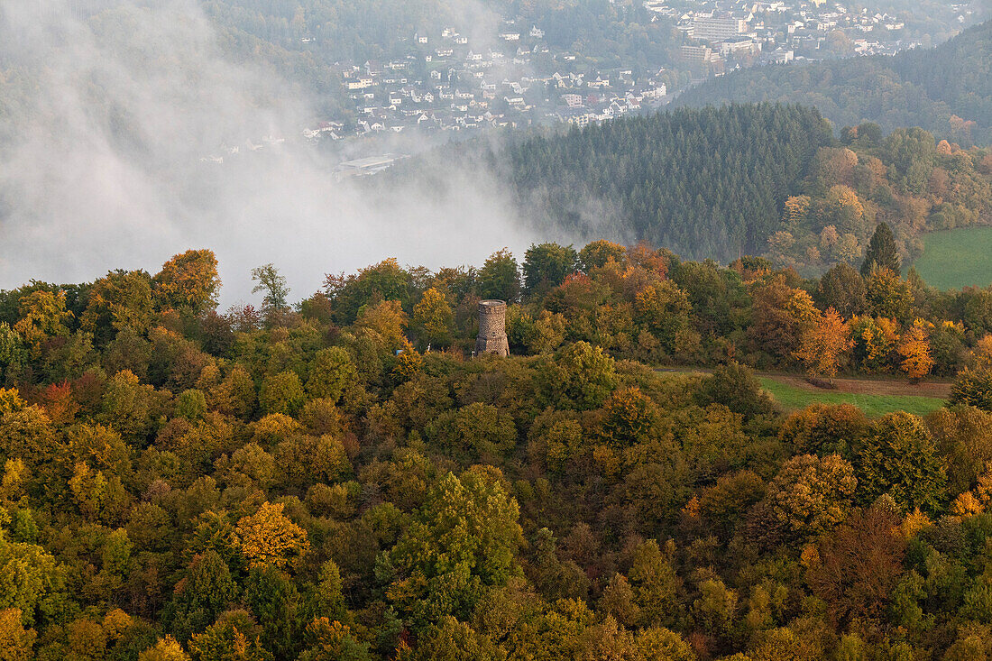 Aerial view of Dronke tower amidst autumnal trees and rising fog, rural district of Rhineland Palatinate, Germany, Europe